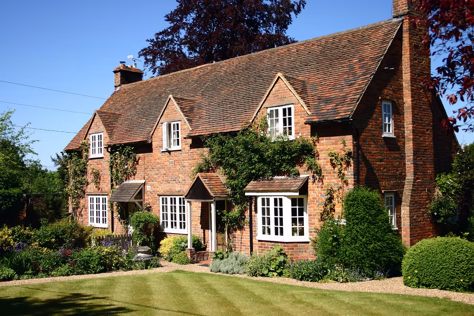 A traditional English country cottage brick built with manicured lawns