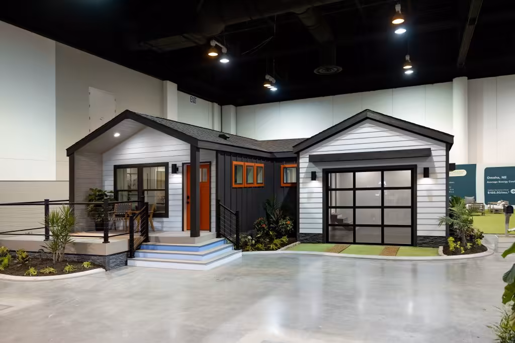 Open-plan interior of a modern manufactured home showing kitchen and living area